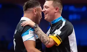 Gerwyn Price, left, is congratulated by Chris Dobey during their World Matchplay encounter