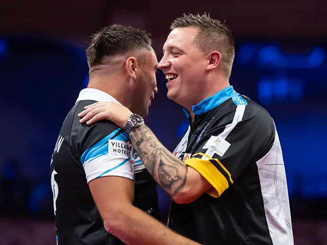 Gerwyn Price, left, is congratulated by Chris Dobey during their World Matchplay encounter