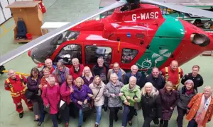 The Loud 'n' Proud line dancing group has raised £15,000 for the Wales Air Ambulance Charity
