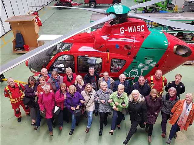 The Loud 'n' Proud line dancing group has raised £15,000 for the Wales Air Ambulance Charity