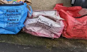 Recycling bags on a pavement in Newport