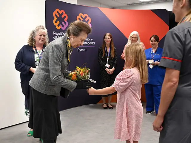 Princess Anne receiving flowers from nine-year-old Lowri Griffiths