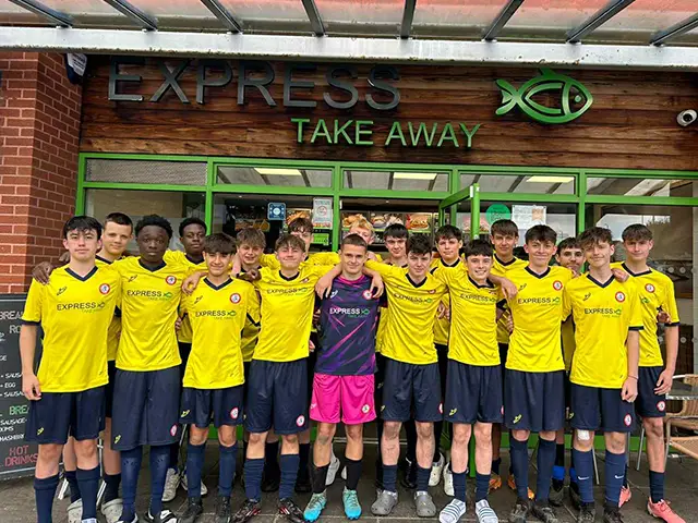 Cwrt Rawlin FC's U16 team outside Express Take Away