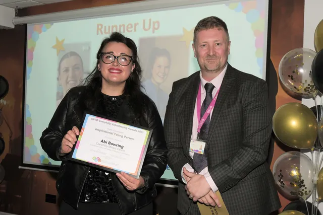 Caerphilly Miners' Centre's Amie Lock accepts the Inspirational Young Person runner-up award from GAVO CEO Stephen Tiley, on behalf of Abi Bowring