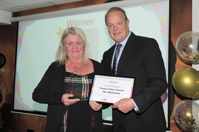 Tracy Lintern-Davies, of Van Allotments, receiving the Family Champion award from Paul Hartshorn of the Weston Group