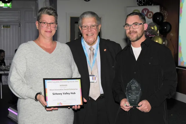 Sirhowy Valley Hub's Mel Parker and Jamie Arr receive their award from GAVO's Edward Watts