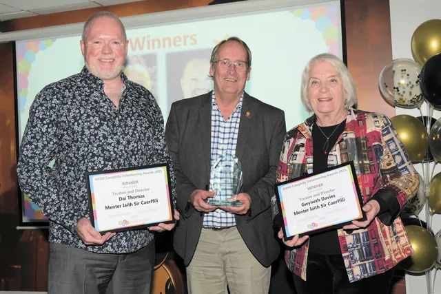 GAVO trustee Robert Dutt, centre, presents the Trustee and Director award to Menter Iaith Sir Caerffili's Dai Thomas and Gwyneth Davies