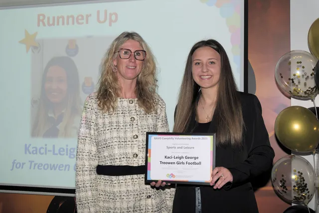 Kaci-Leigh George, left, of Treowen Stars Girls FC, receives her Sport and Leisure runner-up award from Caerphilly Observer's Joanne Burgess