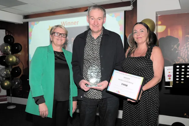 ABUHB chief executive Nicola Prygodzicz, left, presents the Health and Wellbeing award to YYFM's Steven Davies and Catherine Young