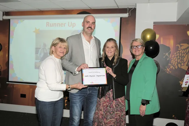 ABUHB chief executive Nicola Prygodzicz, right, presents the Health and Wellbeing runner-up award to Caffi’r Fynnon Argoed Café's Christine George, Rhyddian Jones, and Elvira Edwards