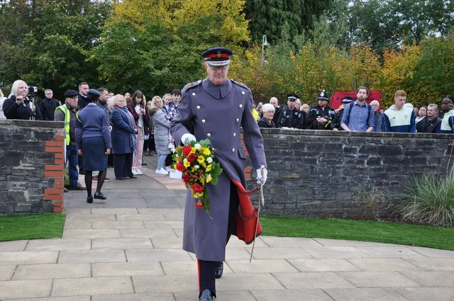 Brigadier Robert Aitken CBE laying his wreath at the memorial