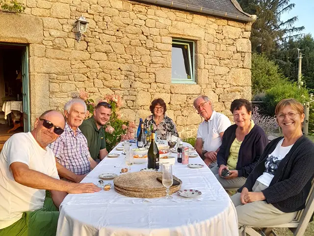 Twinning association members enjoying food and drinks with their Breton hosts