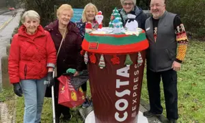 Machen WI members with Co-op store manager Stephen Willey next to the decorated coffee cup