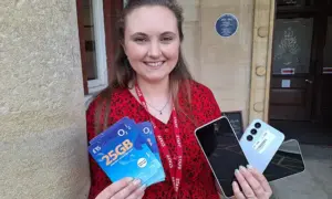 Sophie Davies, of Caerphilly Miners' Centre, with some of the phones and SIM cards being given away