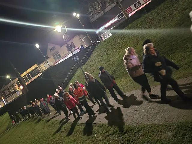 Group members walking through Caerphilly town centre