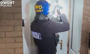 Gwent Police officers carrying out a drug raid in Cefn Fforest