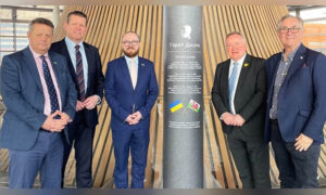 From left: Senedd Members Alun Davies, Rhun ap Iorwerth, Jack Sargeant, Darren Millar, and Mick Antoniw with the Gareth Jones memorial plinth in the Senedd