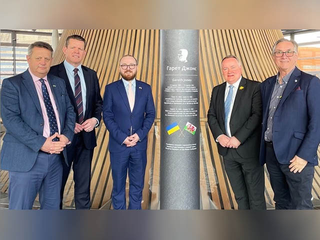 From left: Senedd Members Alun Davies, Rhun ap Iorwerth, Jack Sargeant, Darren Millar, and Mick Antoniw with the Gareth Jones memorial plinth in the Senedd
