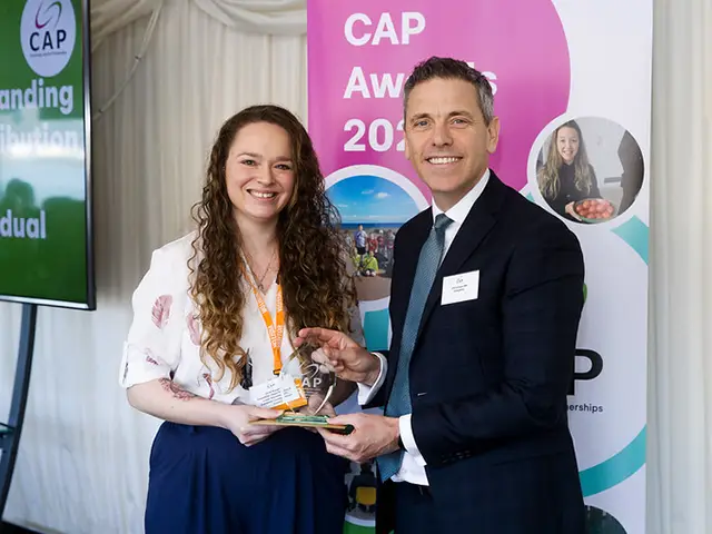 Jamie Burgess receiving her award from Caerphilly MP Chris Evans