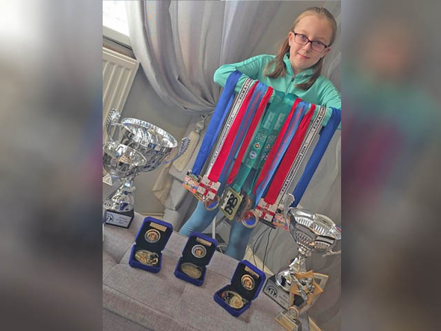 Seren Price with some of her medals and trophies