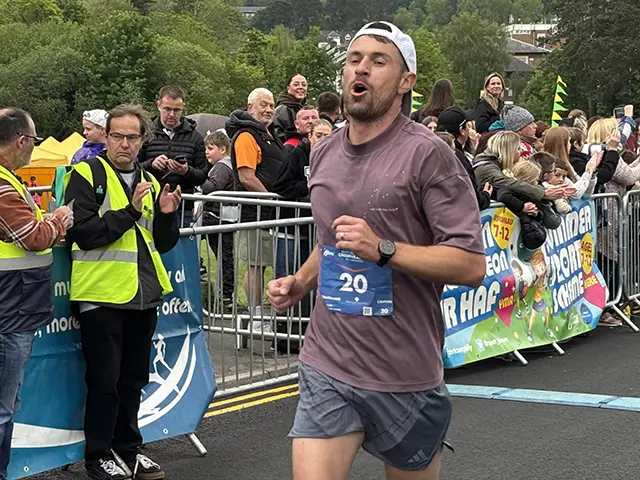 Former Wales captain Aaron Ramsey crossing the finishing line