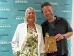Phyllis Levi receiving her award off Jamie Oliver