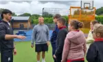 Will Bishop, left, speaking with pupils at Trinity Fields School