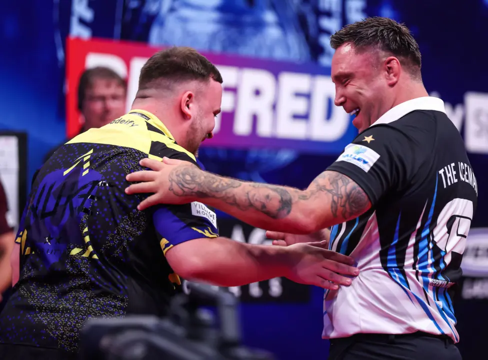 Gerwyn Price, right, with Luke Littler during their encounter in the final
