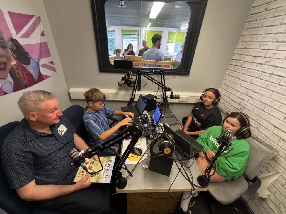Hengoed Primary pupils Logan, Millie, and Evie interview Steve Davies for their school radio station